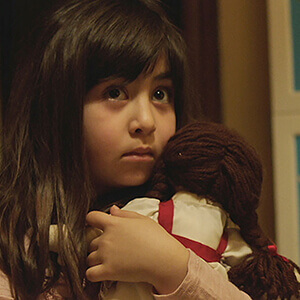 Dorsa clutches her doll